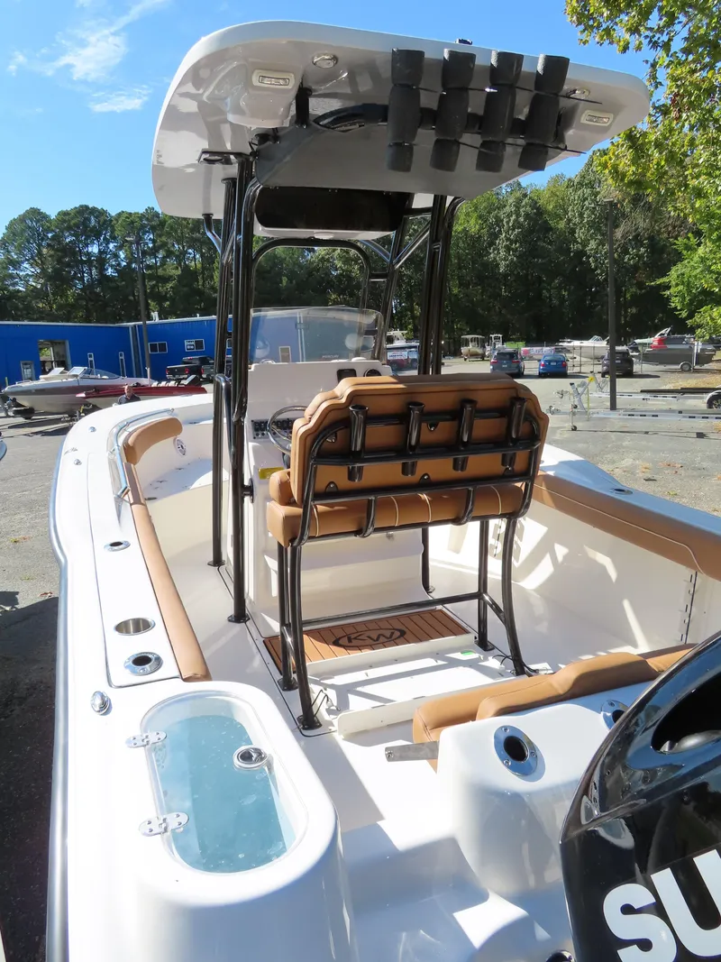 Slide: The Image of 2025 Key West 244 Center Console boat with seating and storage, docked outdoors. - 6