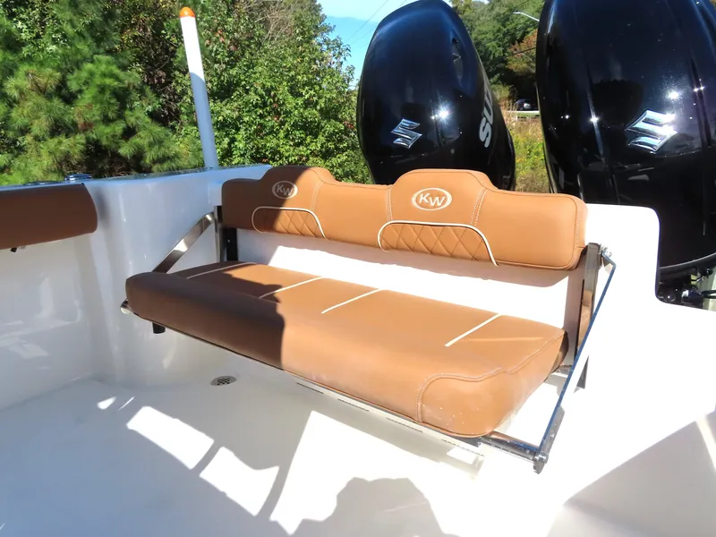 Slide: The Image of 2025 Key West 244 Center Console boat with tan seating and dual outboard motors. - 7