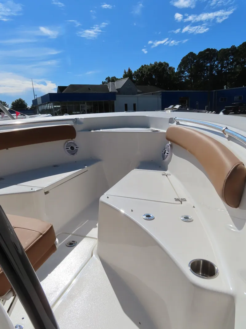 Slide: The Image of 2025 Key West 244 Center Console boat interior with seating and cup holders under a clear sky. - 9