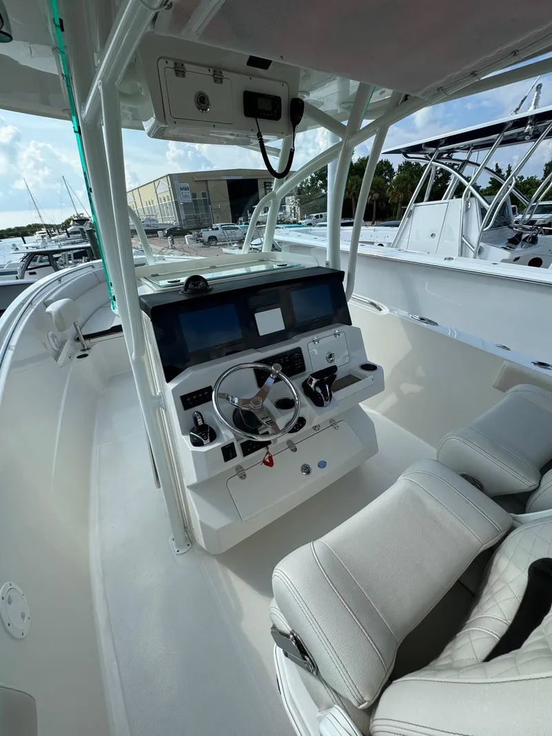 Slide: The Image of 2023 Sailfish 290cc boat cockpit with modern controls and seating. - 9