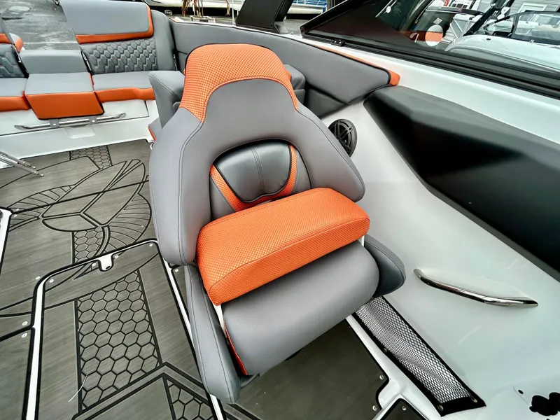 Slide: The Image of 2025 Scarab 255LX boat interior with orange and gray seating, modern design. - 11