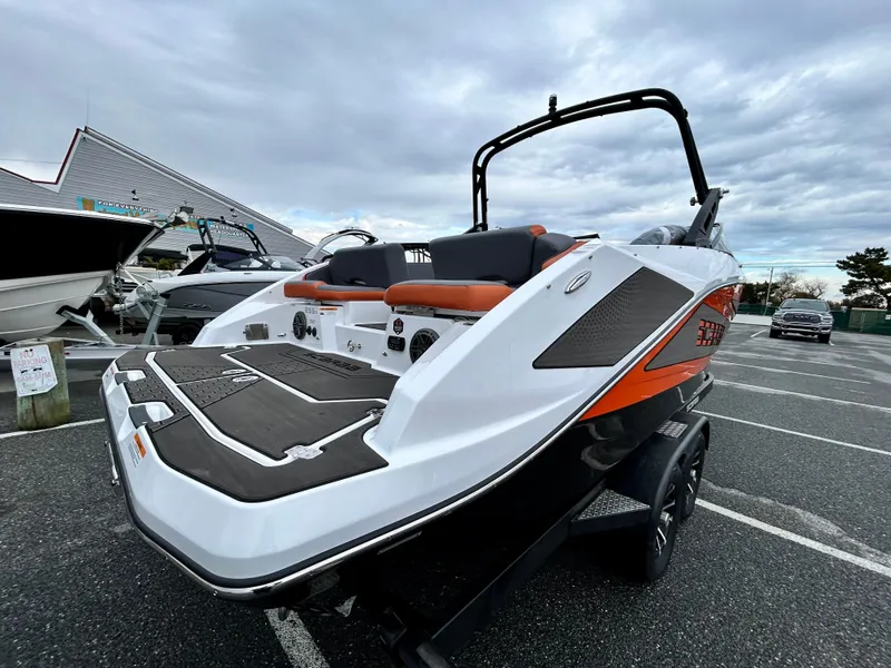 Slide: The Image of 2025 Scarab 255LX boat with sleek design, parked outdoors. - 7