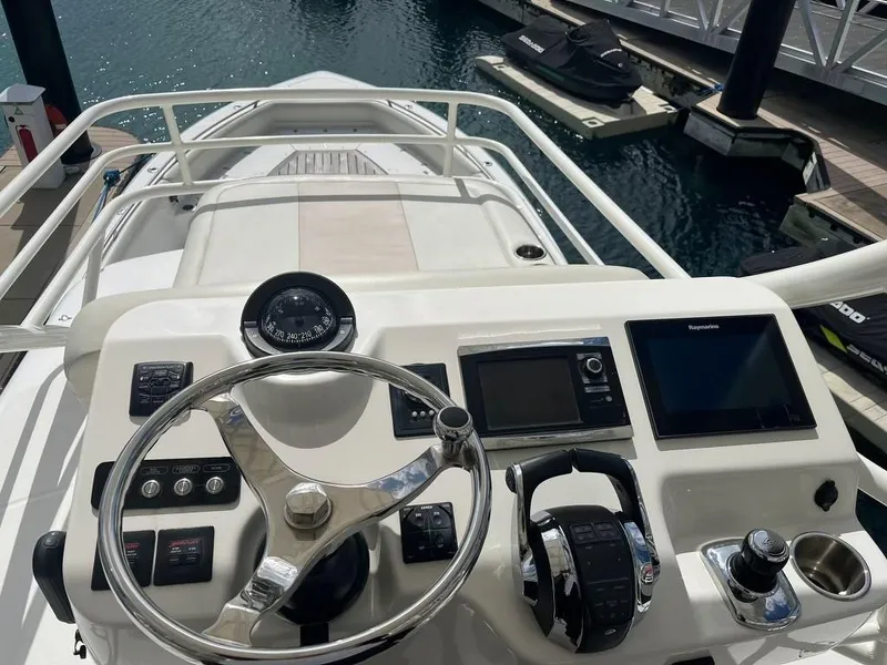 Slide: The Image of Boston Whaler 420 Outrage 2017 helm with steering wheel and navigation controls. - 13