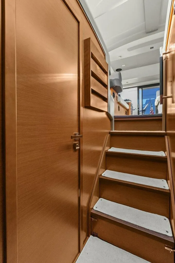 Slide: The Image of Interior stairs of 2014 Prestige 450 S yacht, featuring wooden finish and modern design. - 30