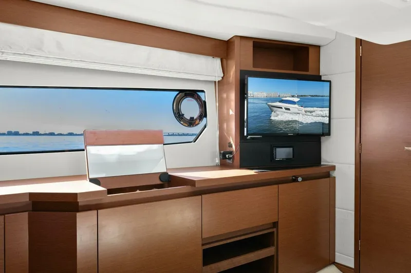 Slide: The Image of Interior of 2014 Prestige 450 S yacht with modern wood cabinetry and window view. - 34
