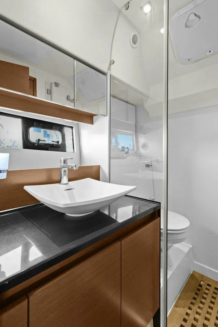 Slide: The Image of Luxurious bathroom in 2014 Prestige 450 S yacht with modern sink and wooden accents. - 38