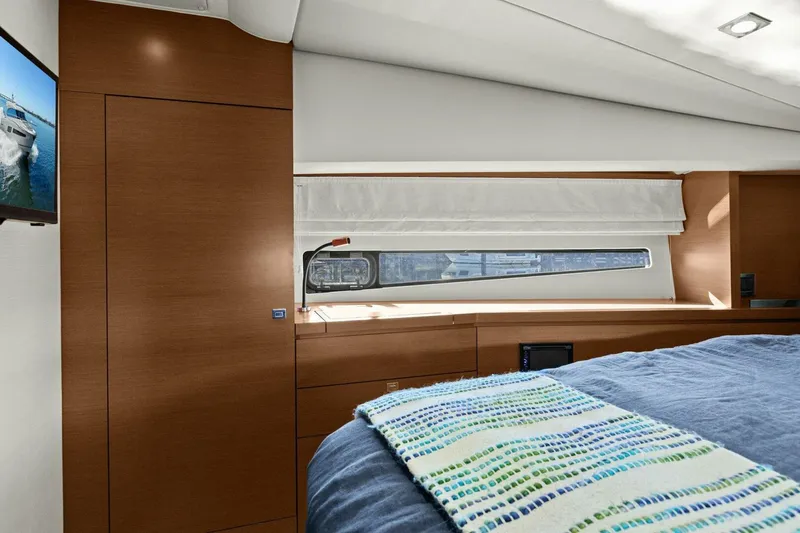Slide: The Image of Luxurious interior of 2014 Prestige 450 S yacht with modern wood finish and cozy bedding. - 44