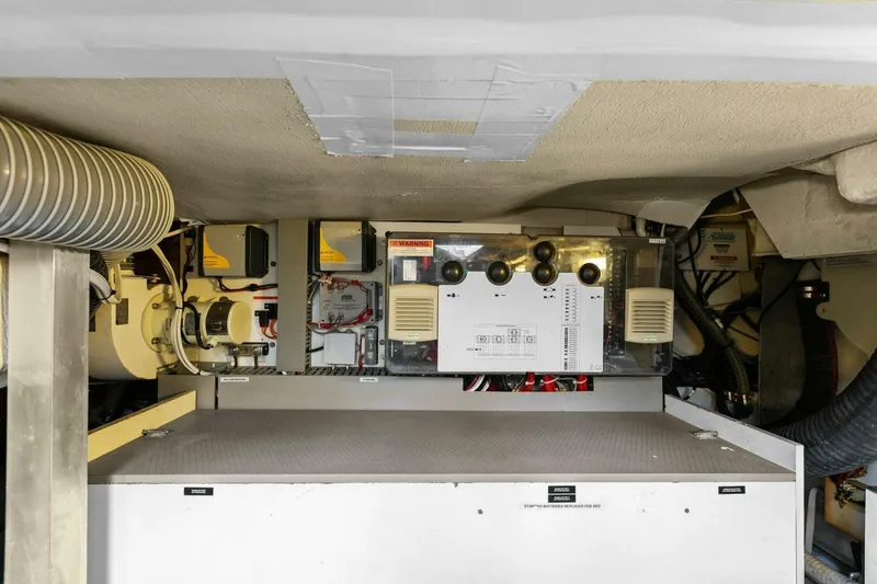 Slide: The Image of Engine room of 2014 Prestige 450 S yacht, showcasing mechanical components and systems. - 49