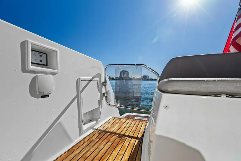 Slide: The Image of Prestige 450 S yacht deck view, 2014 model, overlooking water and cityscape. - 9
