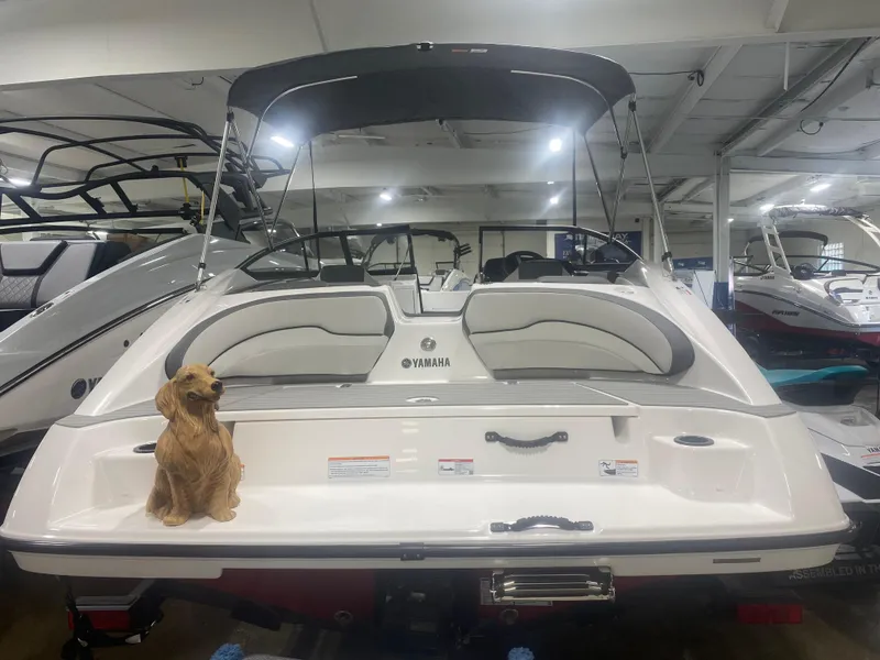 Slide: The Image of 2024 Yamaha SX190 boat with a dog on the deck in a showroom. - 3