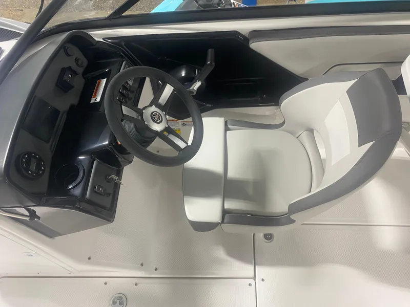 Slide: The Image of 2024 Yamaha Boats SX190 cockpit with steering wheel and captain's seat. - 5