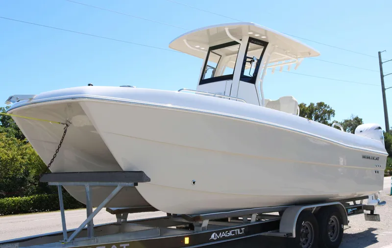The Image of 2025 World Cat 235TE boat on trailer, sleek design, white exterior, ready for transport. - 0