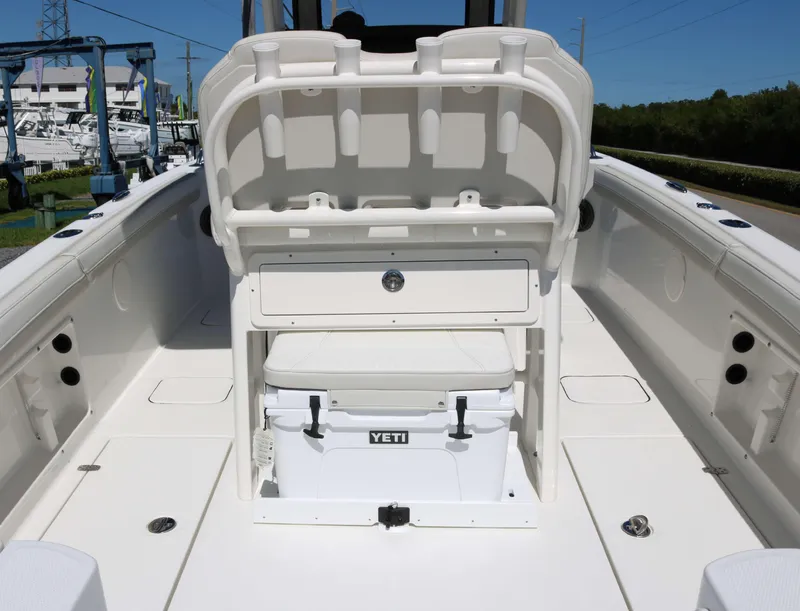 Slide: The Image of 2025 World Cat 235TE boat interior with Yeti cooler and storage compartment. - 12