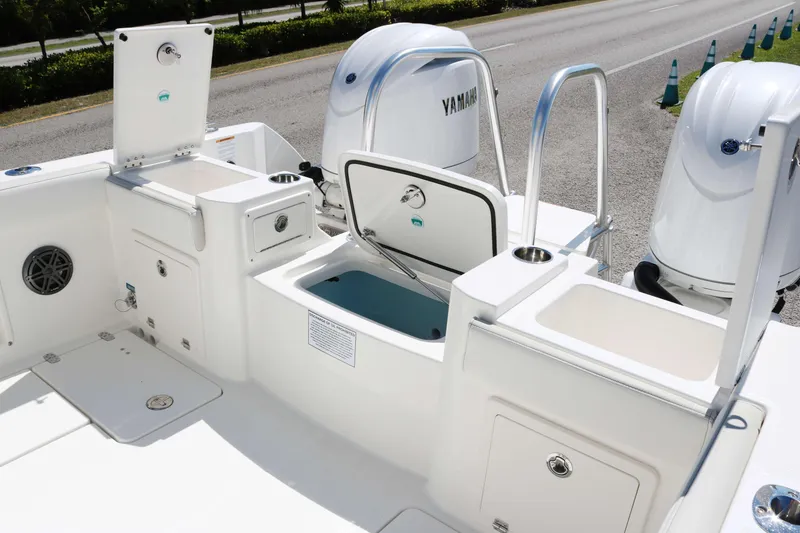 Slide: The Image of 2025 World Cat 235TE boat deck with Yamaha engines and storage compartments. - 14