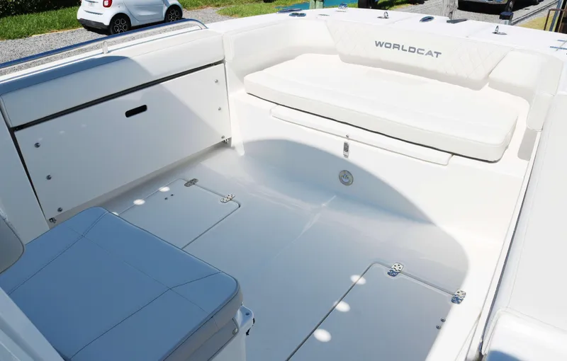 Slide: The Image of 2025 World Cat 235TE boat interior, featuring spacious seating and storage compartments. - 9