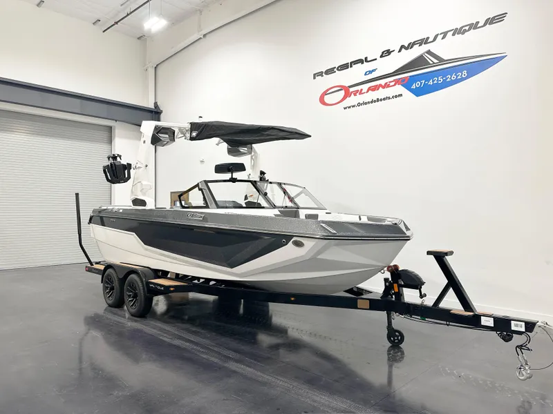 Slide: The Image of 2025 Nautique GS20 boat on trailer in showroom. - 3