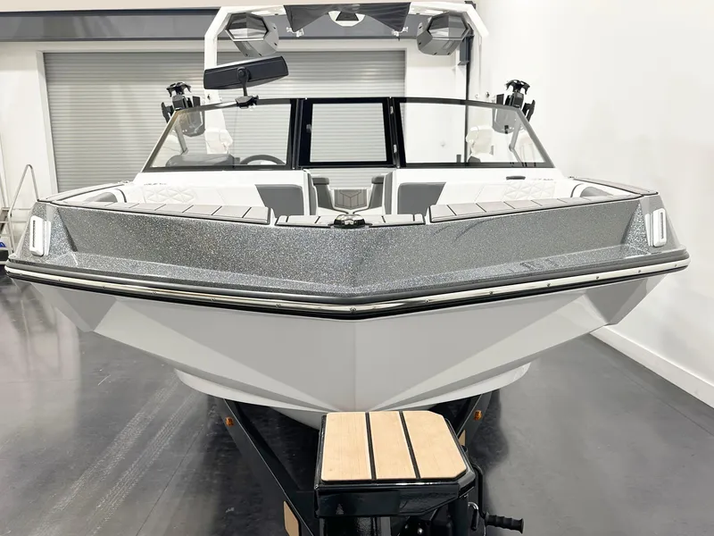 Slide: The Image of 2025 Nautique GS20 boat in showroom, front view, sleek design. - 4
