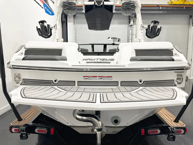 Slide: The Image of 2025 Nautique GS20 boat rear view in a garage setting. - 5