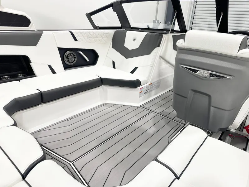 Slide: The Image of 2025 Nautique GS20 boat interior with sleek white and gray seating and modern design. - 9