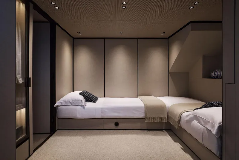 Slide: The Image of Luxurious Sanlorenzo SP92 2026 yacht bedroom with twin beds and modern decor. - 33