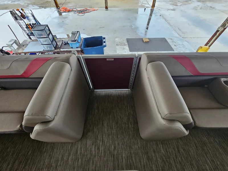 Slide: The Image of Interior of 2021 Bennington 22 SX pontoon boat with beige seating and red accents. - 11