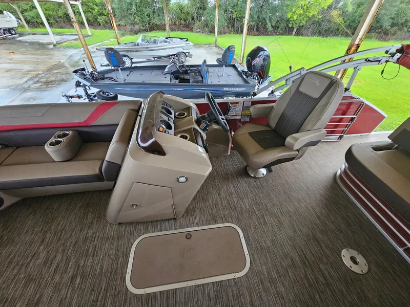 Slide: The Image of 2021 Bennington 22 SX boat interior with steering console and seating. - 13