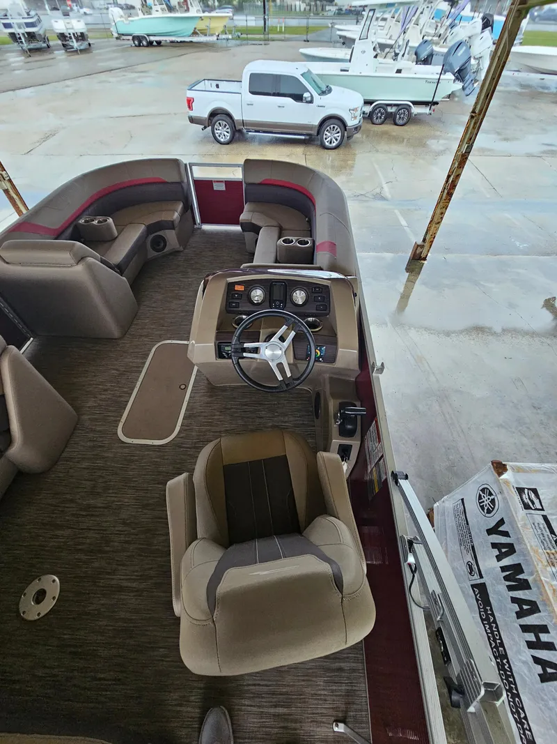 Slide: The Image of 2021 Bennington 22 SX pontoon boat interior with steering wheel and seating. - 15