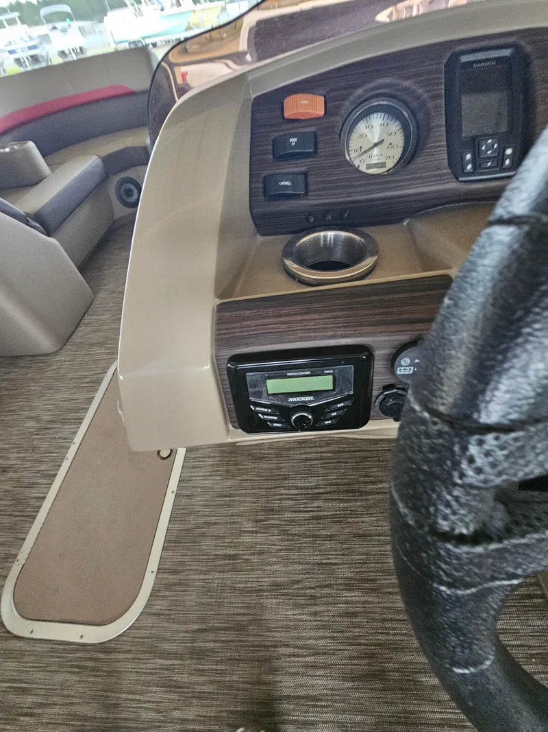 Slide: The Image of 2021 Bennington 22 SX boat dashboard with controls and steering wheel. - 16