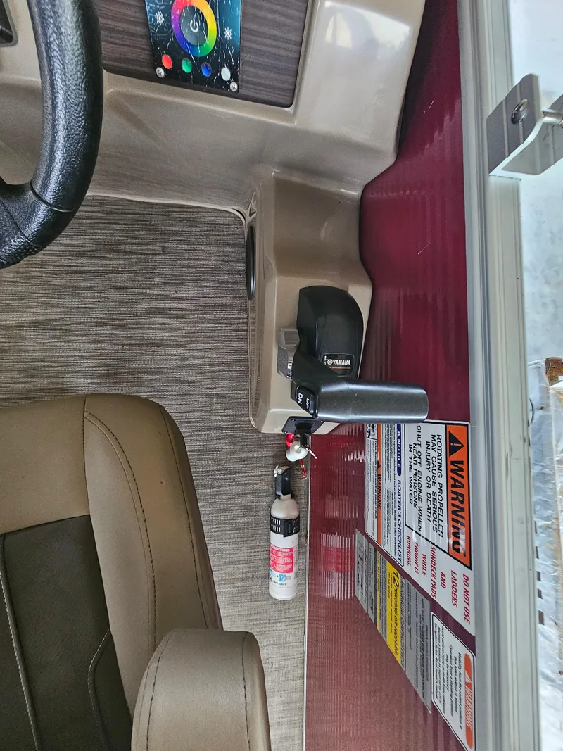 Slide: The Image of Interior of a 2021 Bennington 22 SX boat with control panel and safety labels. - 17