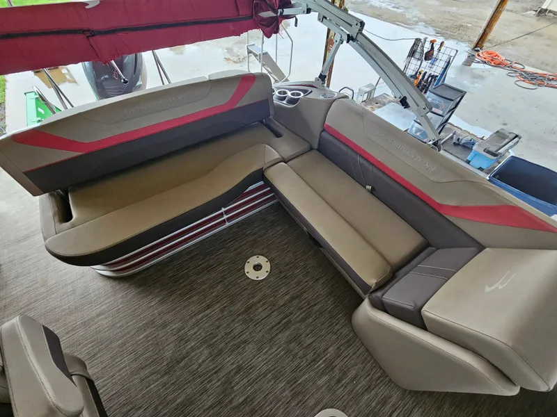 Slide: The Image of 2021 Bennington 22 SX pontoon boat interior with beige and red seating. - 20