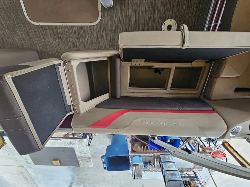 Slide: The Image of 2021 Bennington 22 SX boat interior with open storage compartments and seating. - 21
