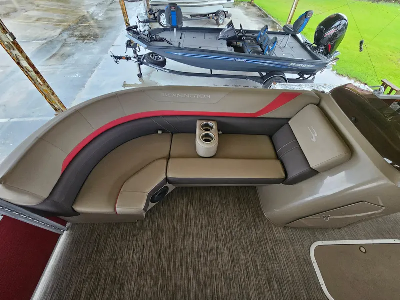 Slide: The Image of 2021 Bennington 22 SX pontoon boat interior with cushioned seating and cup holders. - 6
