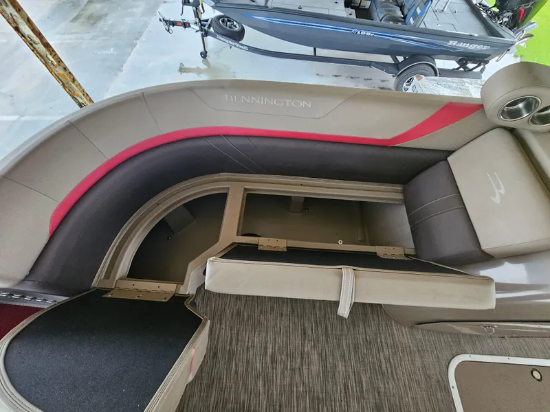Slide: The Image of 2021 Bennington 22 SX boat interior with open storage compartment and seating. - 7