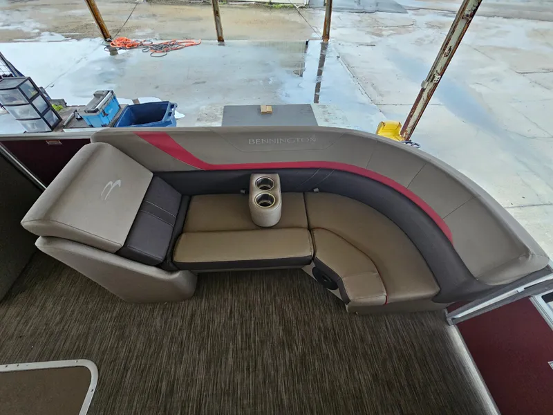 Slide: The Image of 2021 Bennington 22 SX boat interior with curved seating and cup holders. - 8