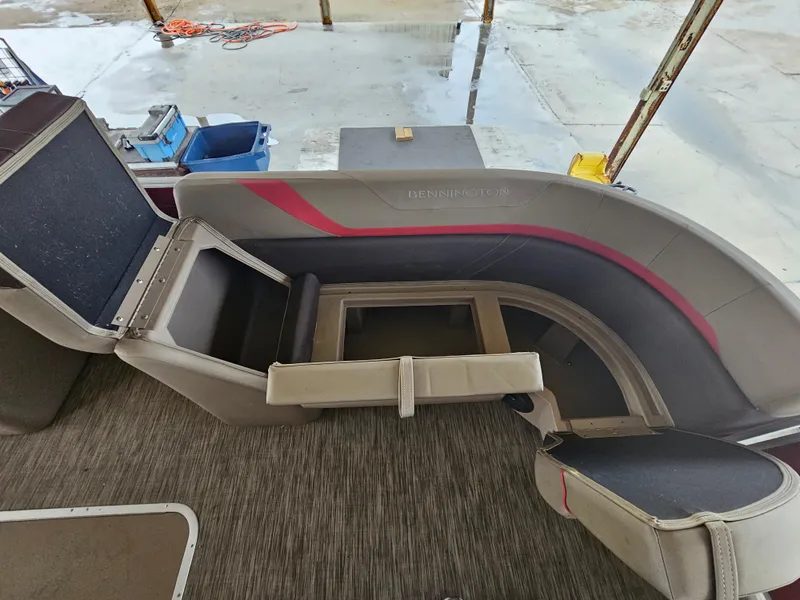 Slide: The Image of 2021 Bennington 22 SX boat interior with open storage compartments. - 9