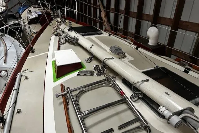 Slide: The Image of 1984 Sea Sprite 34 Yawl sailboat deck with mast and rigging in storage. - 14