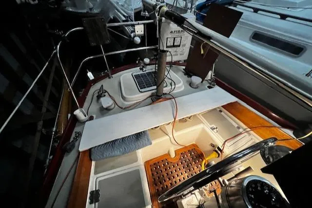 Slide: The Image of 1984 Sea Sprite 34 Yawl cockpit with navigation equipment and wooden accents. - 15