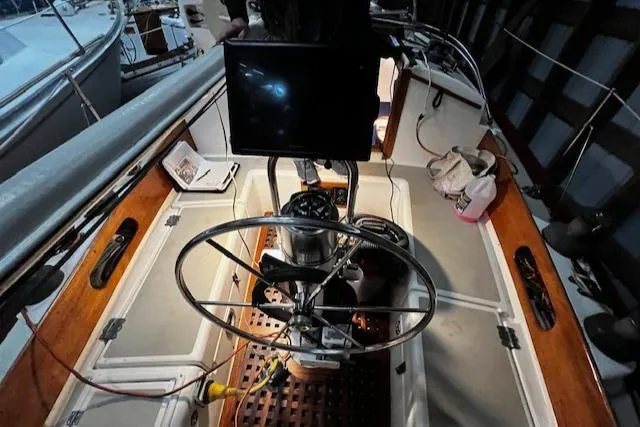 Slide: The Image of 1984 Sea Sprite 34 Yawl cockpit with steering wheel and navigation equipment. - 16