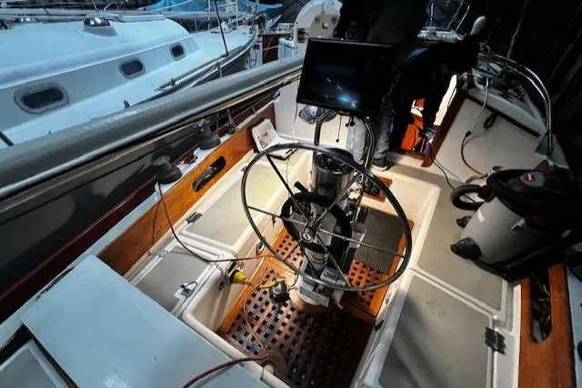 Slide: The Image of 1984 Sea Sprite 34 Yawl cockpit with steering wheel and navigation equipment. - 17