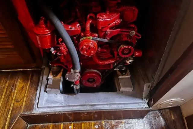Slide: The Image of Engine compartment of a 1984 Sea Sprite 34 Yawl, featuring a red-painted engine. - 18