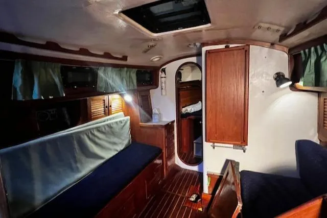 Slide: The Image of Interior of 1984 Sea Sprite 34 Yawl, featuring wooden cabinetry and seating. - 4