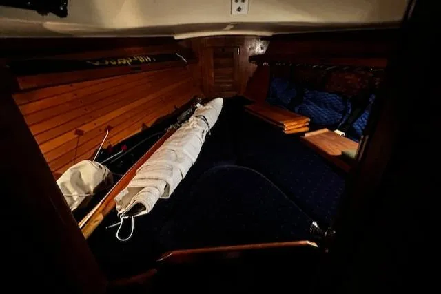 Slide: The Image of Interior cabin of 1984 Sea Sprite 34 Yawl with wooden paneling and stored sail. - 7