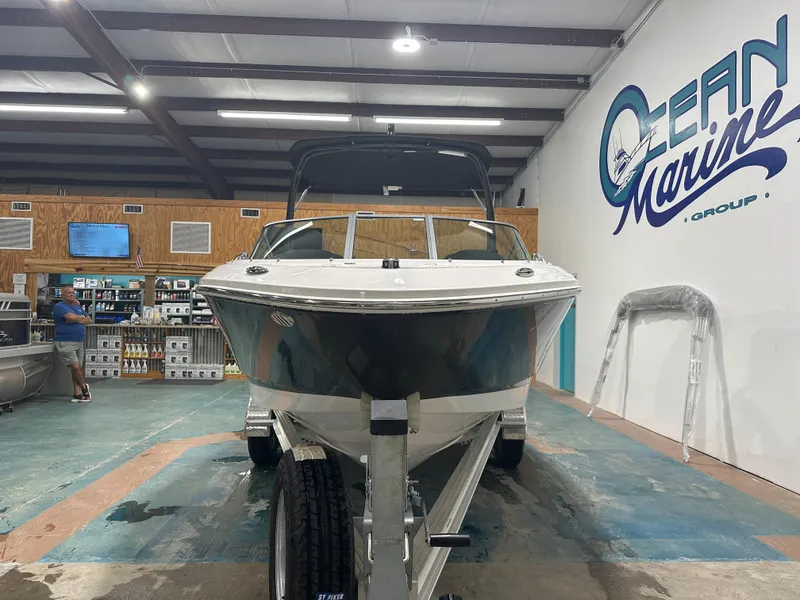 Slide: The Image of 2024 Chaparral SSI21SP boat displayed indoors at Ocean Marine Group showroom. - 1
