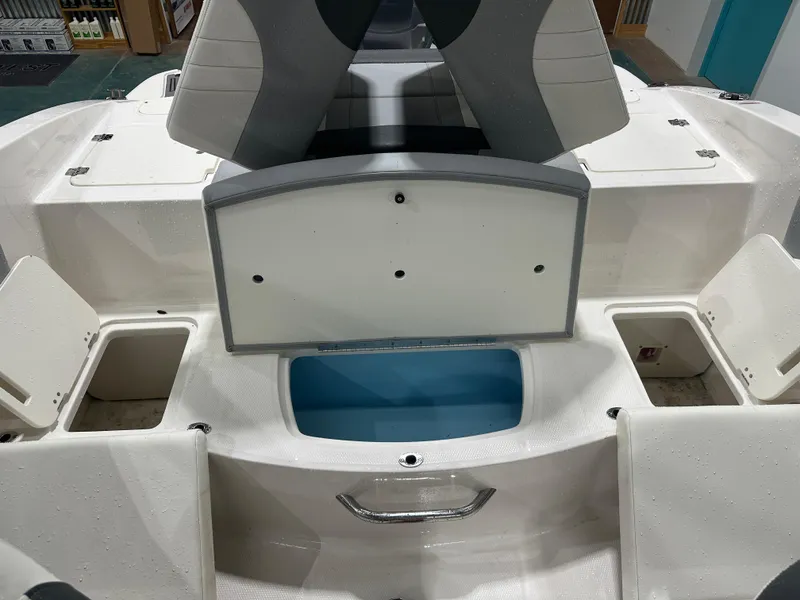Slide: The Image of 2024 Chaparral SSI21SP boat interior with storage compartments and seating. - 21