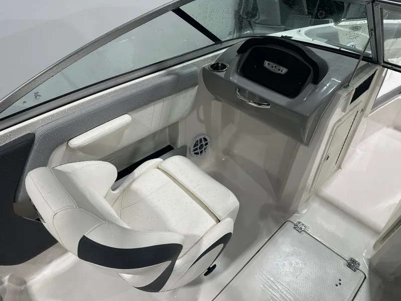 Slide: The Image of 2024 Chaparral SSI21SP boat interior with white seating and dashboard. - 23