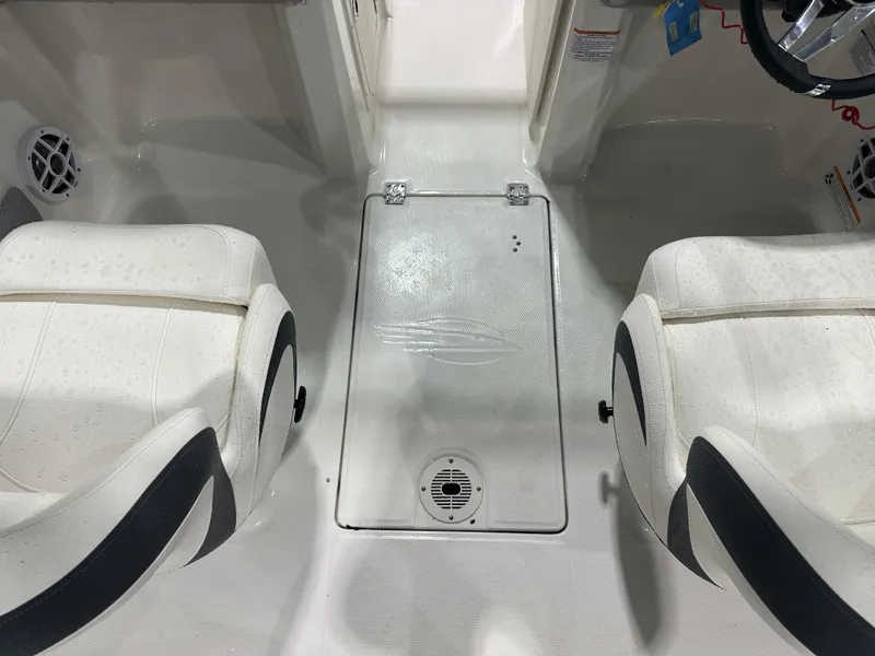 Slide: The Image of 2024 Chaparral SSI21SP boat interior with white seating and steering wheel. - 24