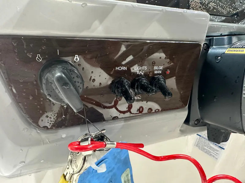 Slide: The Image of 2024 Chaparral SSI21SP boat control panel with switches and keys. - 26