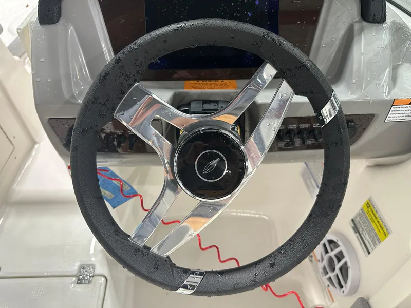 Slide: The Image of 2024 Chaparral SSI21SP steering wheel with sleek design and modern controls. - 29
