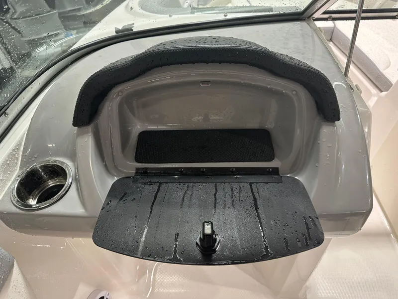 Slide: The Image of 2024 Chaparral SSI21SP boat dashboard with storage compartment and cup holder. - 32
