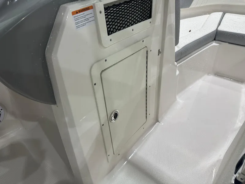 Slide: The Image of 2024 Chaparral SSI21SP boat interior with storage compartment and seating area. - 33